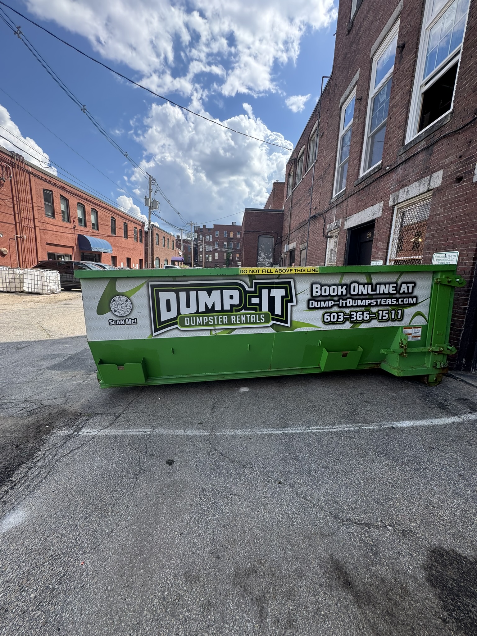 Dump-It Dumpster Rentals logo over a construction site