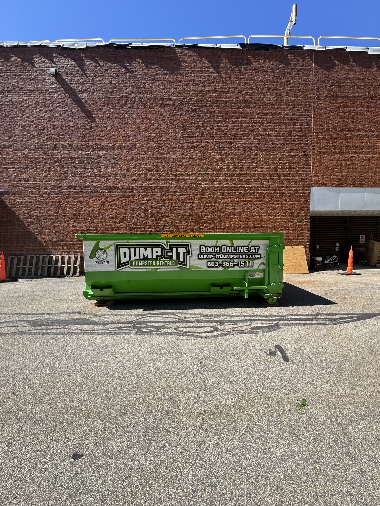 Dump-It Dumpster Rentals logo over a construction site