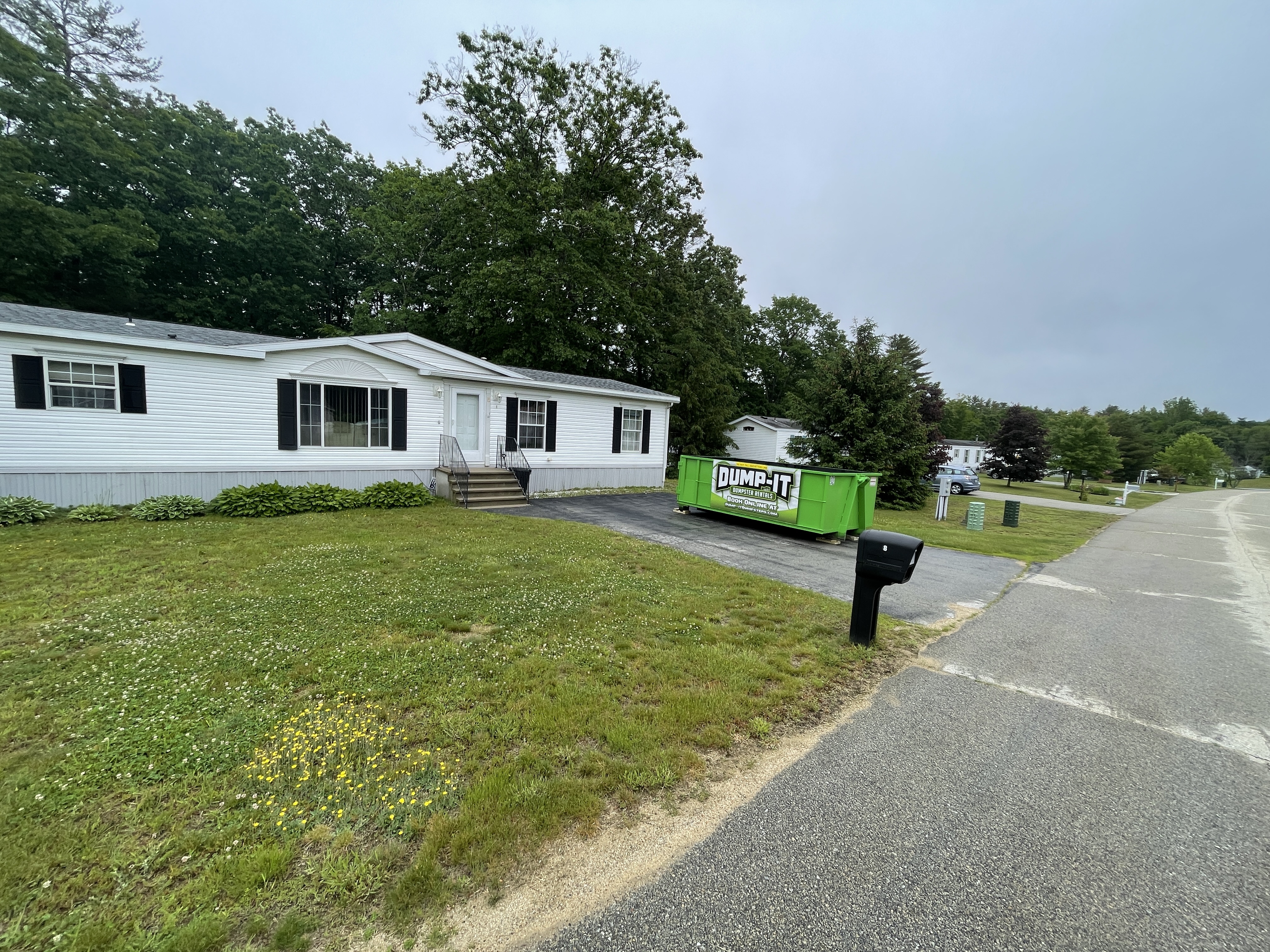 Two dumpsters from Dump-It Dumpster Rentals side by side