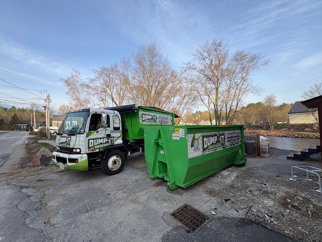 Residential dumpster from Dump-It Dumpster Rentals placed in a backyard