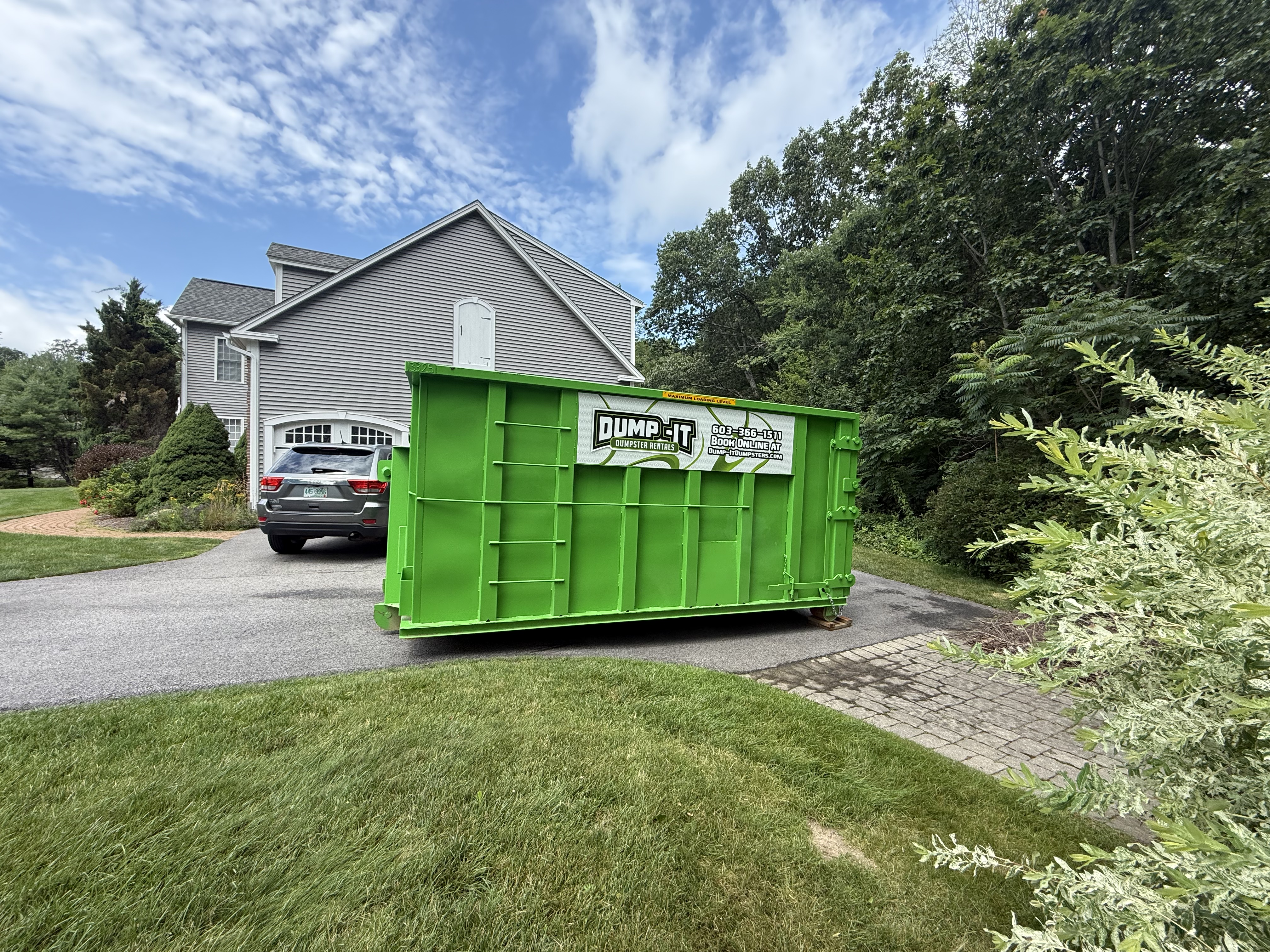 Dump-It Dumpster Rentals logo over a construction site