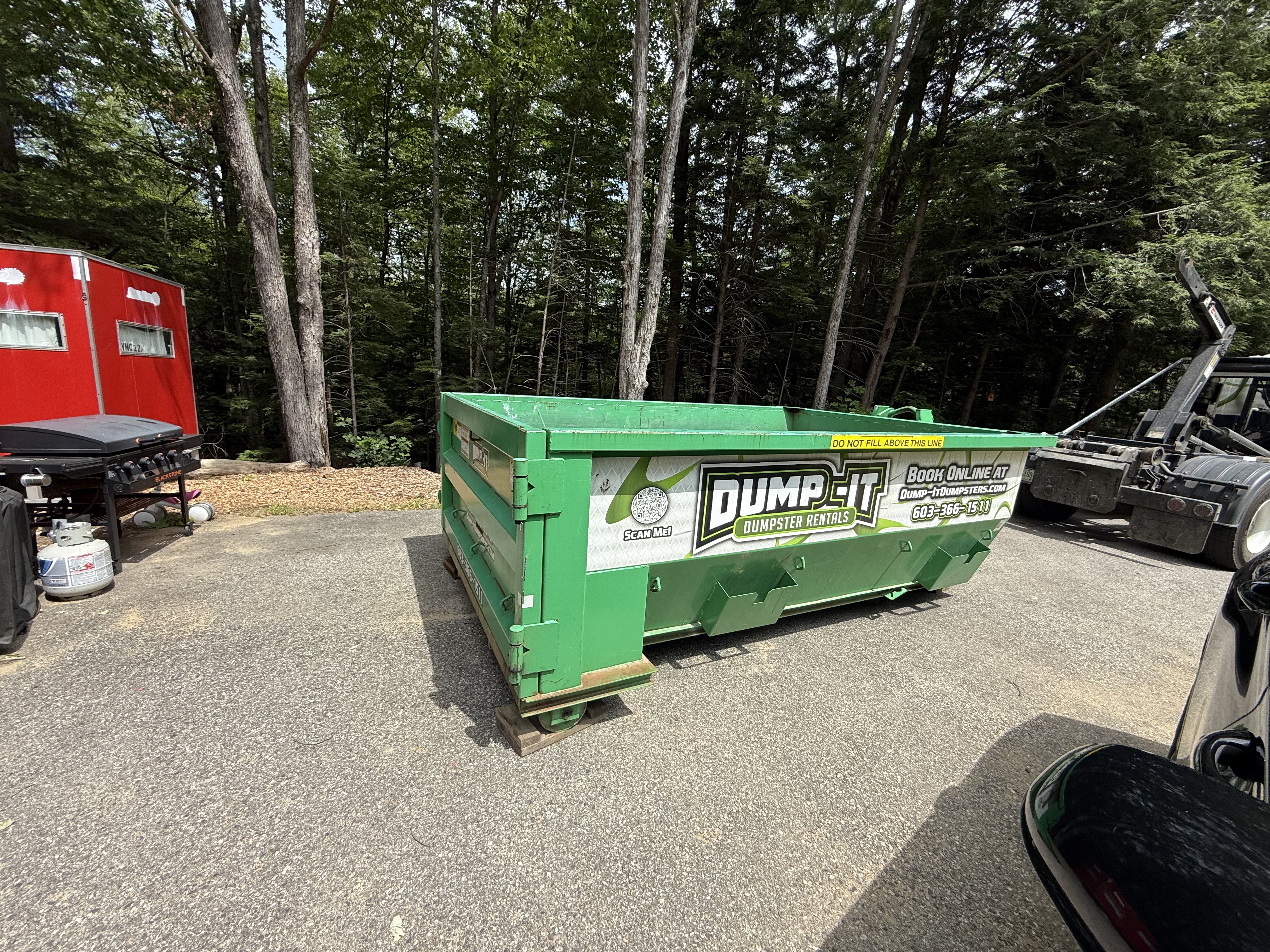 Dump-It Dumpster Rentals" logo over a construction site.