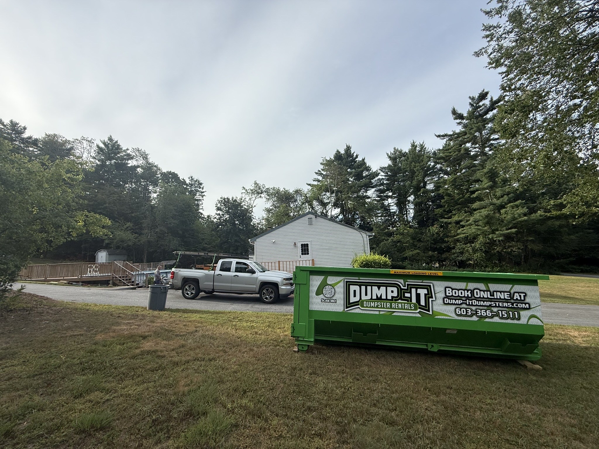 Residential dumpster from Dump-It Dumpster Rentals placed in a backyard