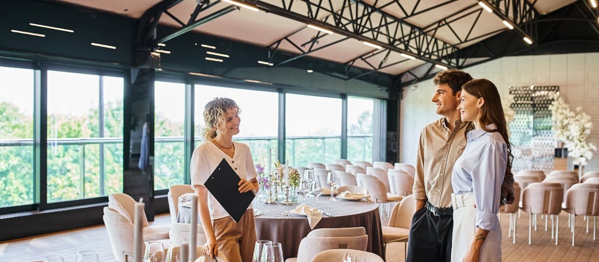 Event planner meeting couple in decorated venue