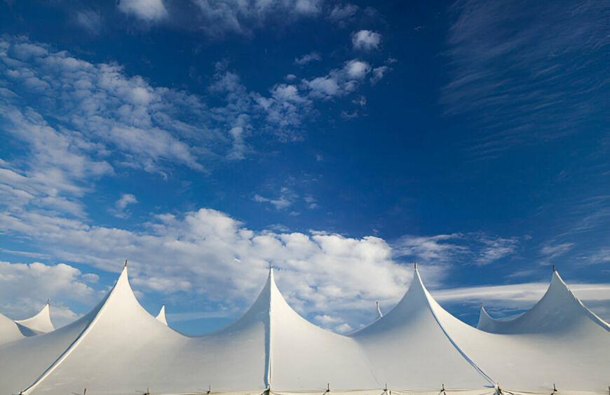 White event tents under blue sky