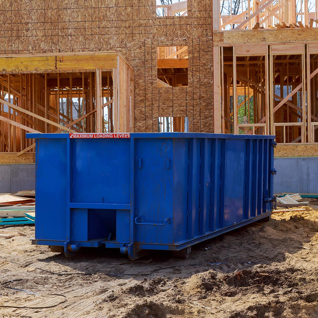 blue dumpster at a construction site