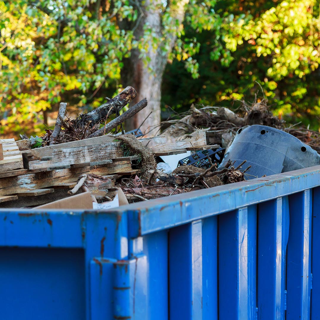 blue dumpster full of waste