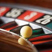 Casinos | Roulette ball sitting in a roulette wheel