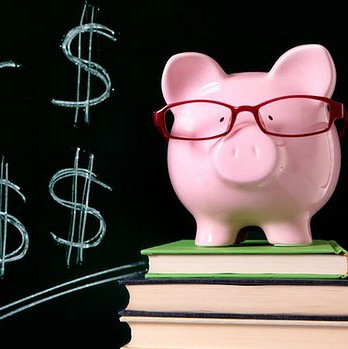 Schools | Piggy bank and textbooks in front of a chalkboard