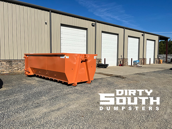 Commercial roll-off dumpster from Dirty South Dumpsters placed in front of a business storefront for cleanup and waste removal in Little Rock, AR Commercial roll-off dumpster from Dirty South Dumpsters placed in front of a business storefront for cleanup and waste removal in Little Rock, AR