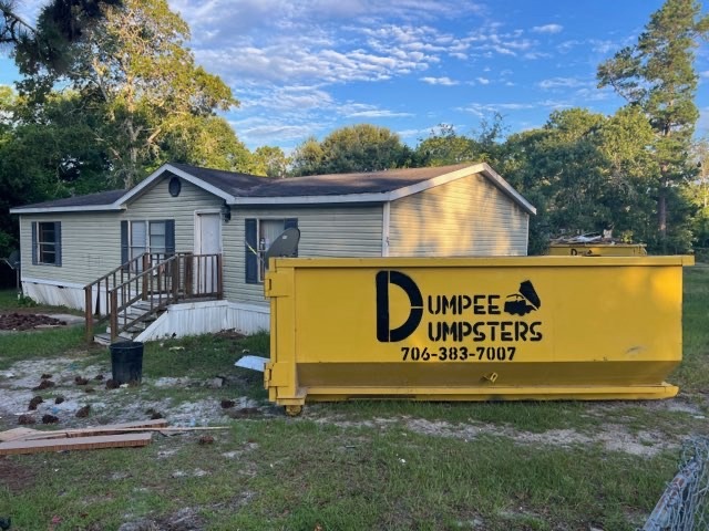 Dumpster at the curb of a residential home from Dumpee Dumpster Rentals Dumpster at the curb of a residential home from Dumpee Dumpster Rentals