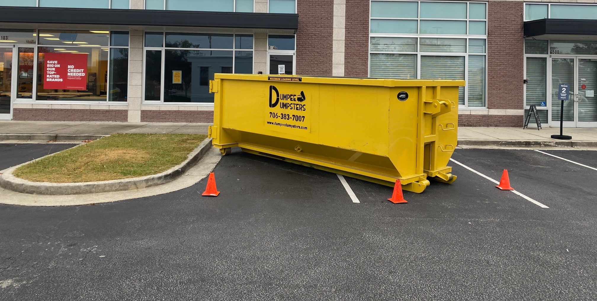 Commercial dumpster filled with debris at a job site from Dumpee Dumpsters Commercial dumpster filled with debris at a job site from Dumpee Dumpsters