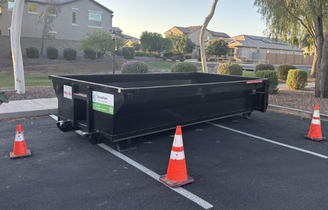 Roll-off container set in a designated parking area for debris collection by Dump Right LLC