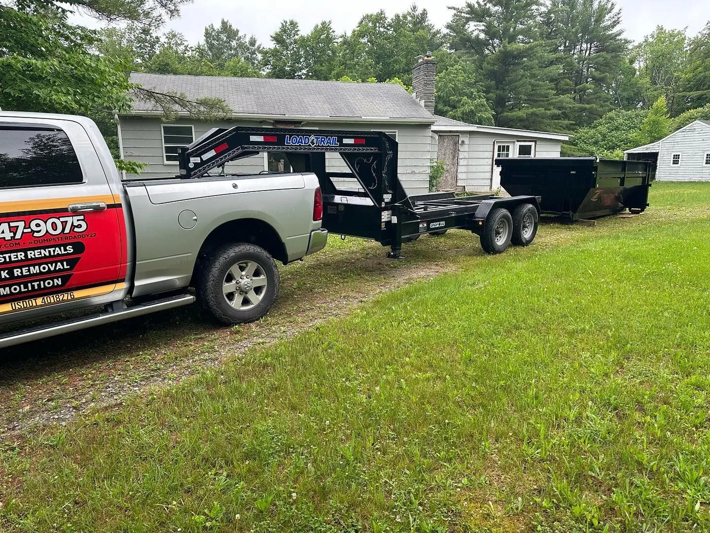 Dumpster Daddy roll-off dumpster trailer parked for residential cleanup service