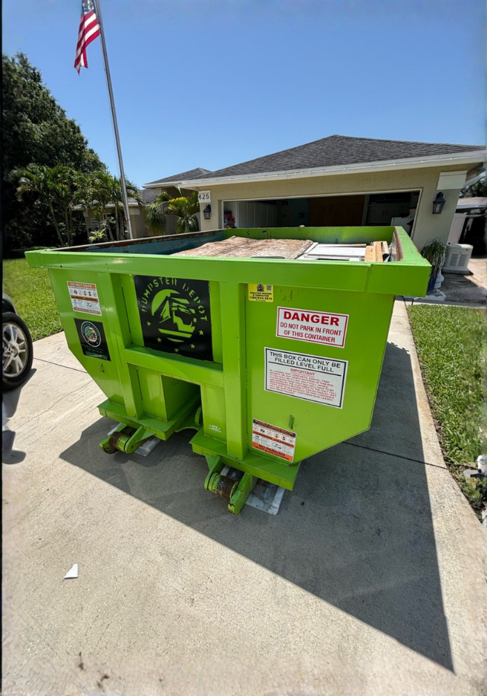 Dumpster Depot lime green roll-off bin on a residential driveway.
Dumpster Depot lime green roll-off bin on a residential driveway.