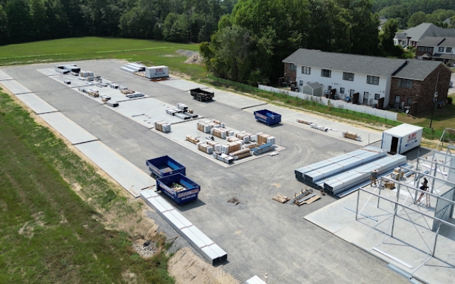 Dumpsters at a construction site with building materials from Dumpster Pro NC