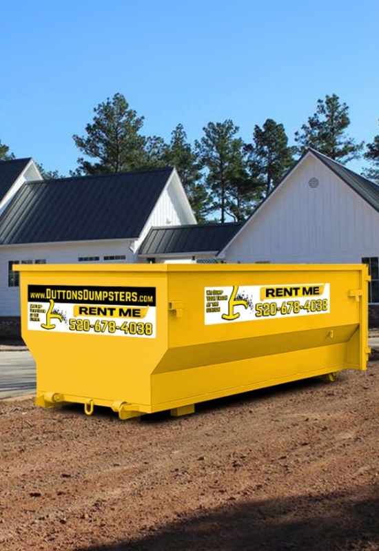 Yellow roll-off dumpster placed outside a house for debris removal with Dutton Dumpsters