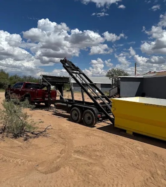 Red pickup truck towing a trailer with a yellow roll-off dumpster from Dutton Dumpsters