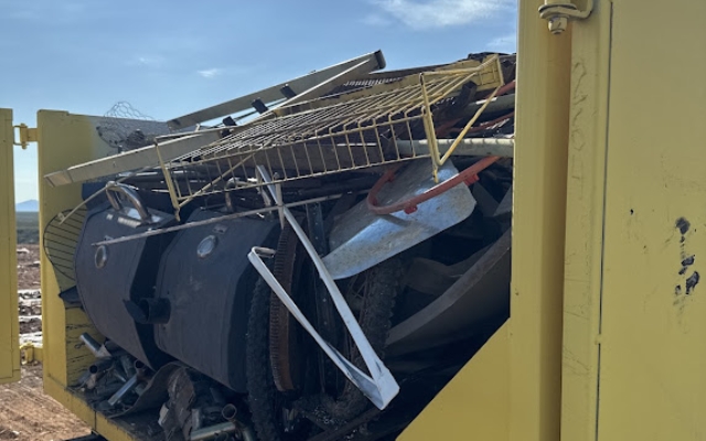 Large roll-off dumpster filled with industrial debris from Dutton Dumpsters