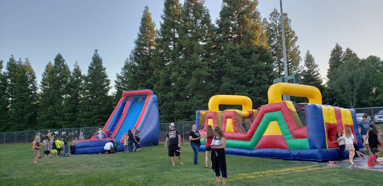 E&J Funday water slide and obstacle course rentals at a youth softball and athletic league event