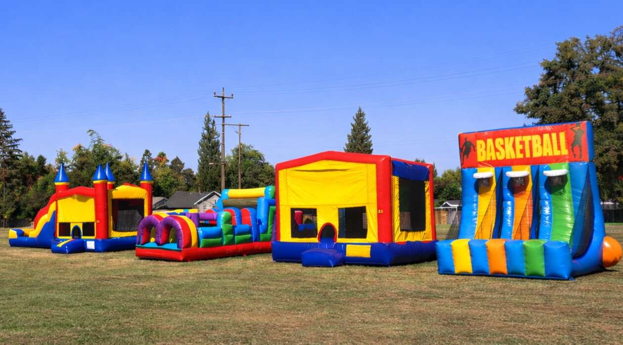 Bounce houses, obstacle course, and inflatable basketball game rentals set up for a large Carmichael church, school, or sports event