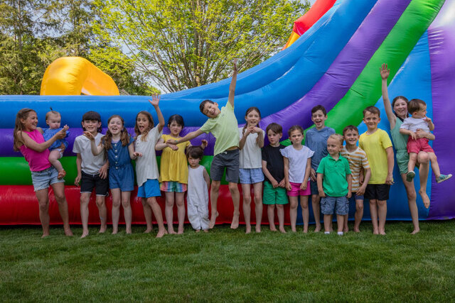 Happy kids playing in a bounce house at a party