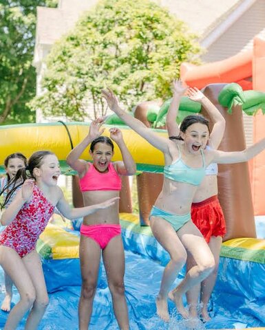 Kids playing on an inflatable water slide