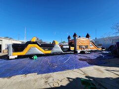Orange and black obstacle course with waterslide