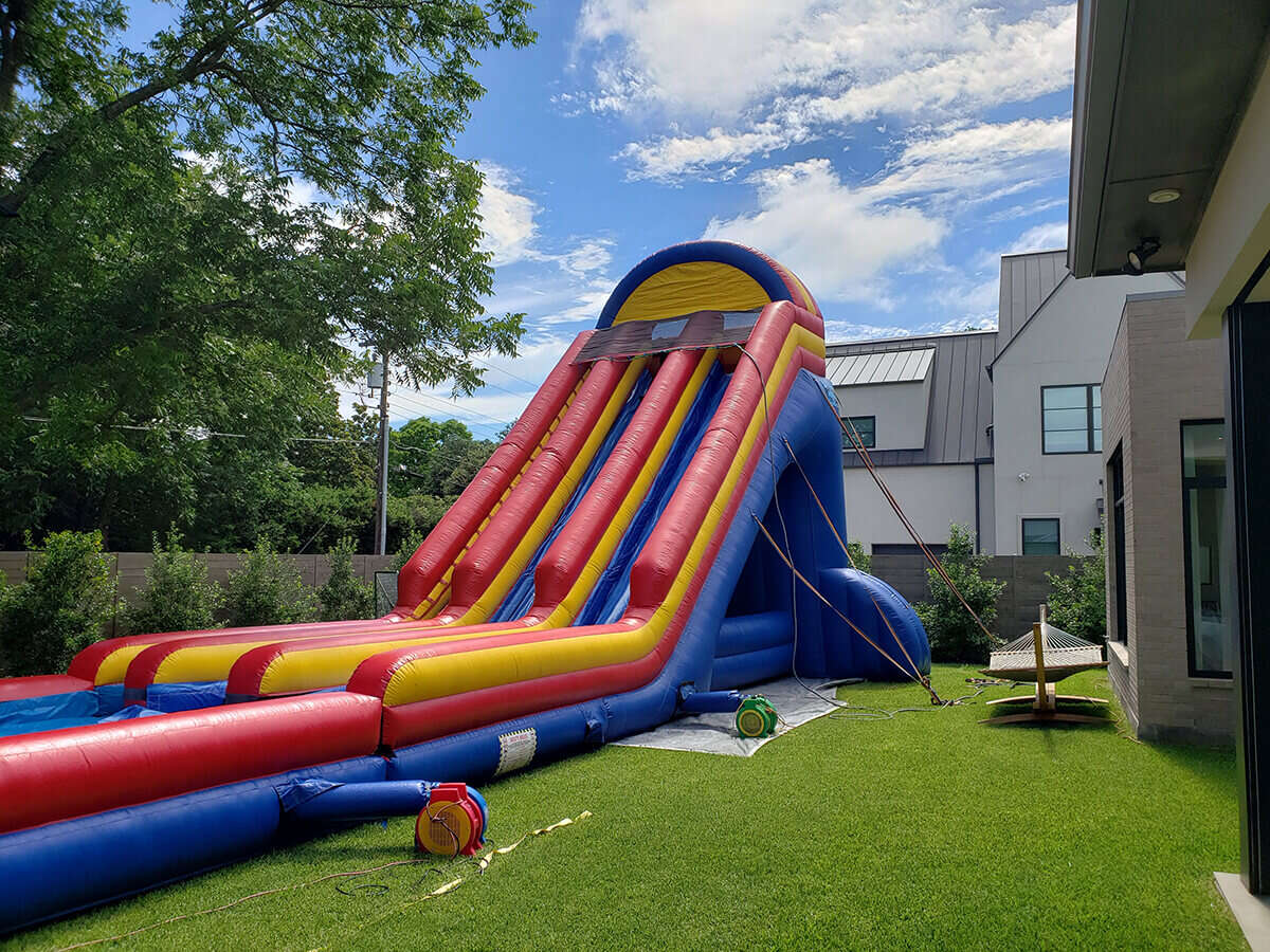 27-foot water slide set up for a backyard celebration