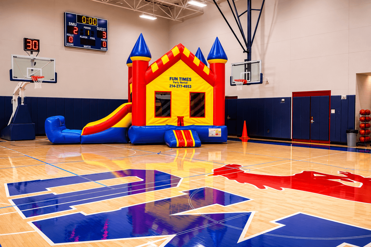 Combo bounce house with slide setup in a gym
