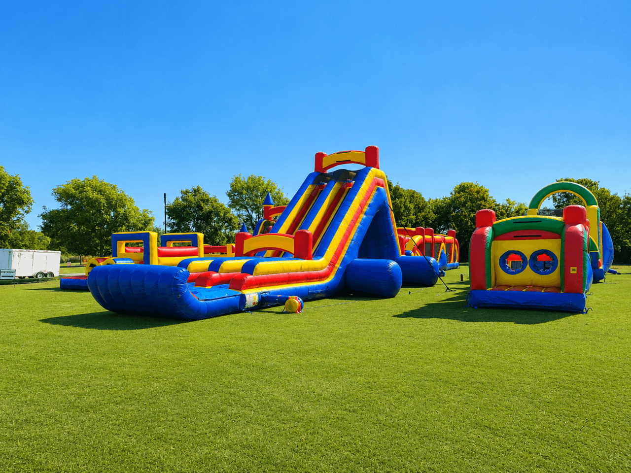 Large inflatable obstacle course setup for a community festival event