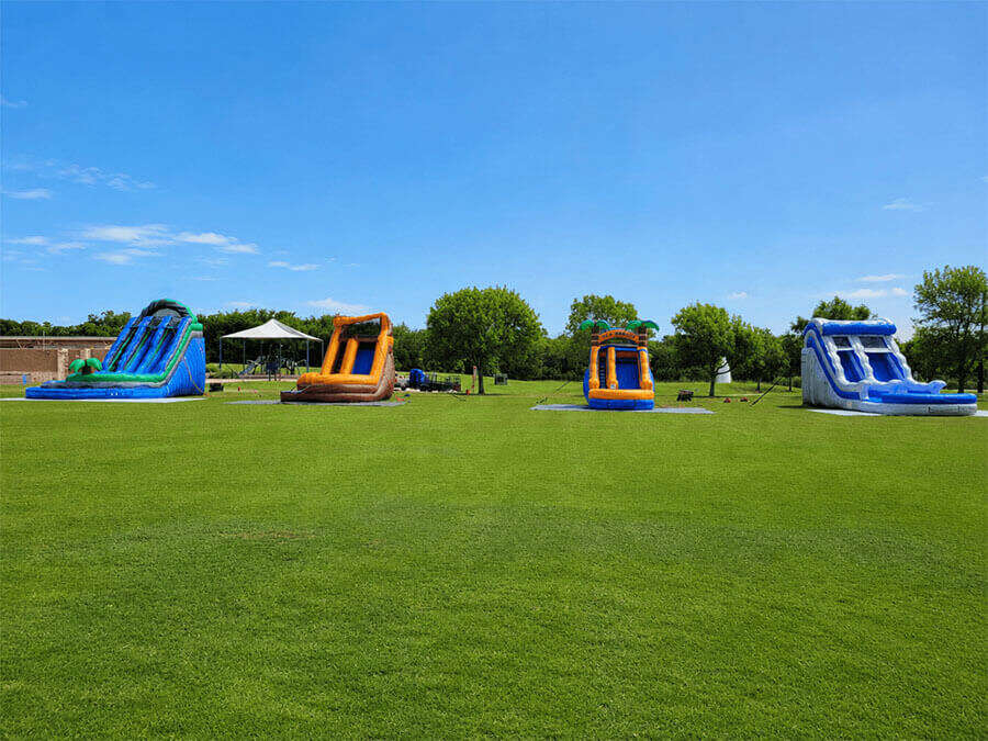 Water slide rentals setup for a summer community event in North Texas
