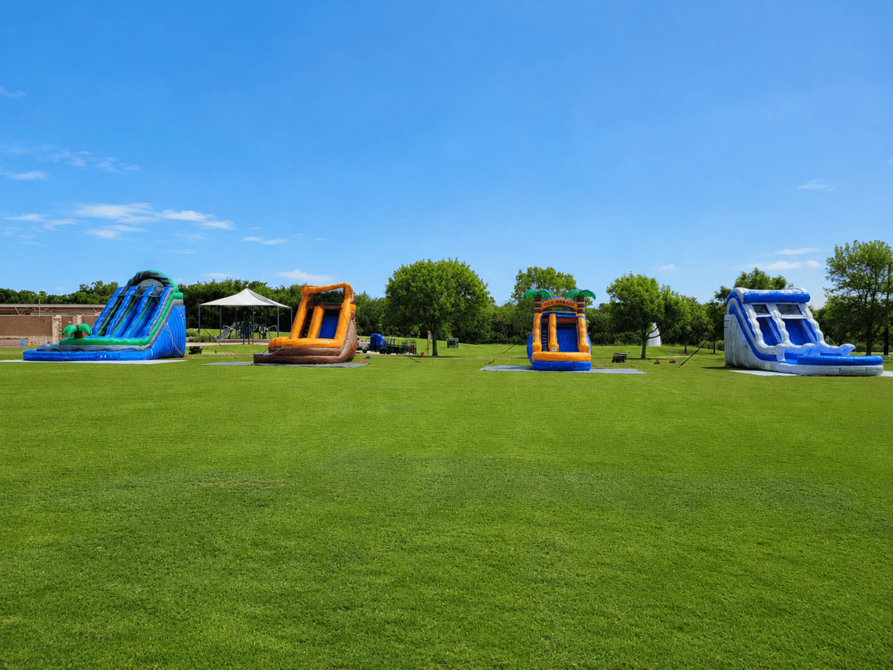 Water slide rentals setup for a summer community event in North Texas
