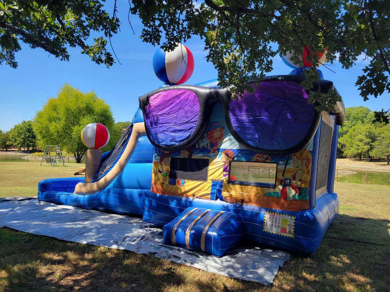 Backyard inflatable combo set up on grass with room around the attraction