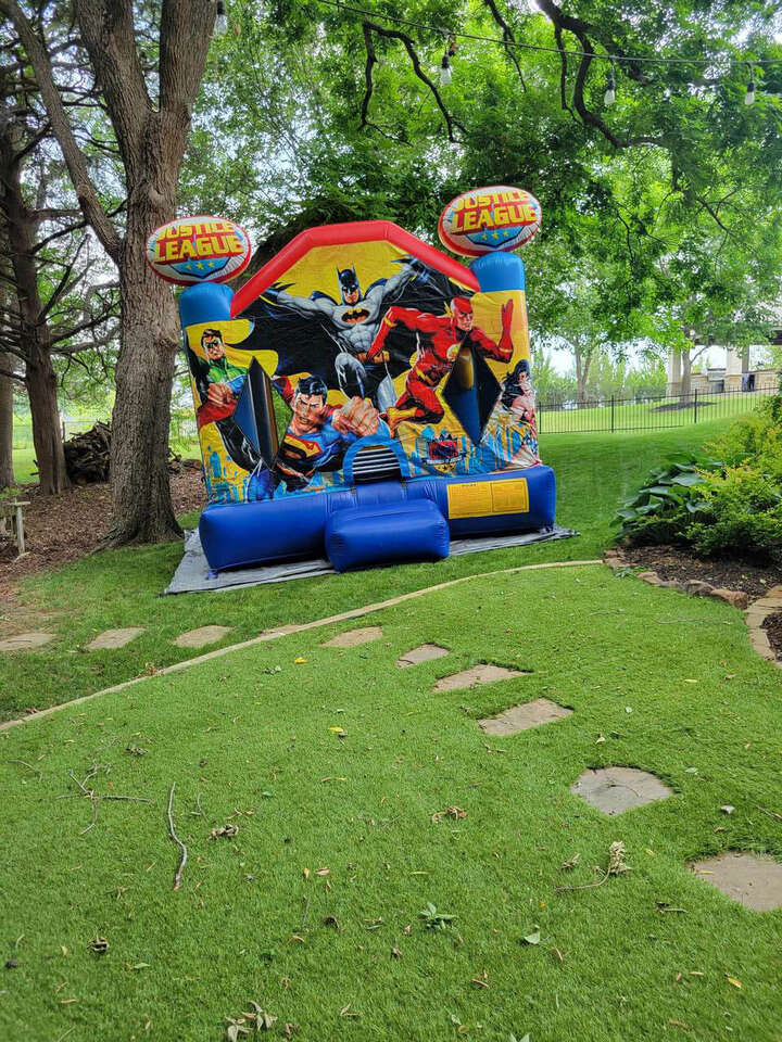 Kids bounce house rental set up outdoors for a party