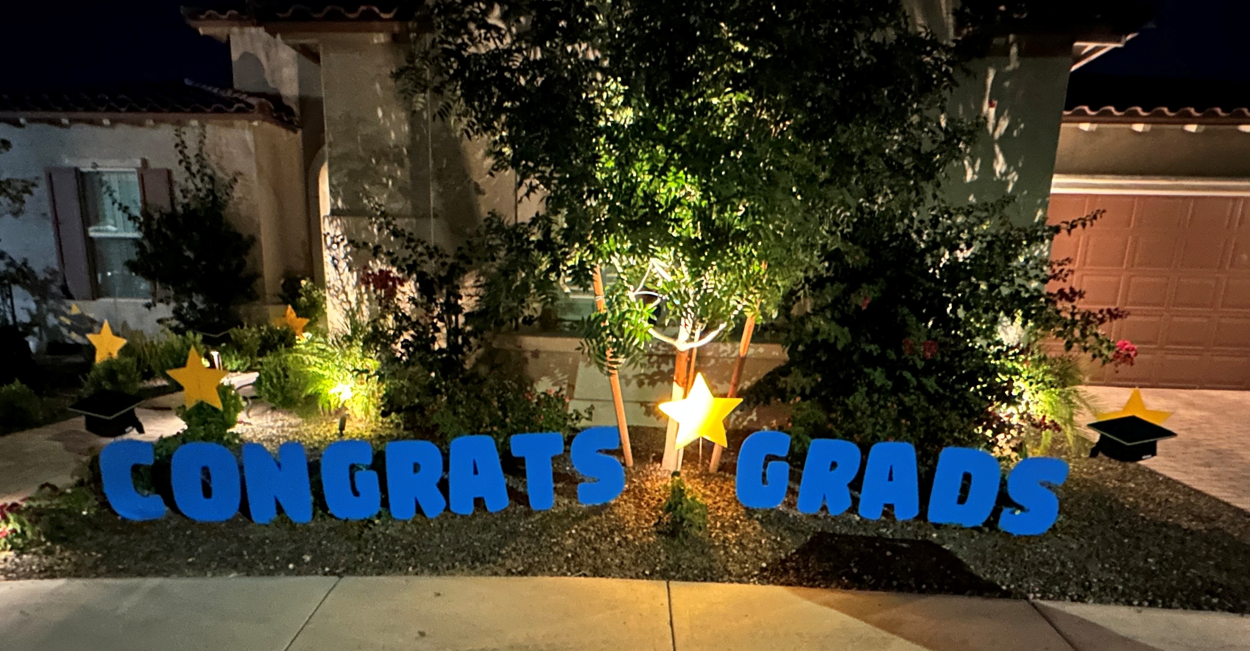 Graduation lawn announcement near Paradise Valley AZ of grad caps, numbers, stars and hearts in yard decorations