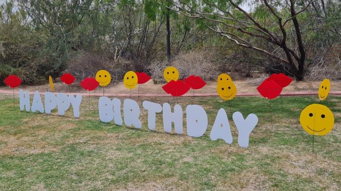 orange Happy Birthday letter 13s and smileys yard signs