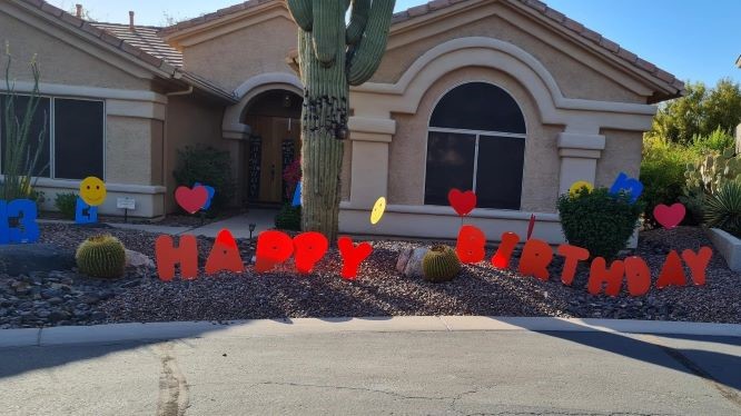 orange Happy Birthday letter 13s and smileys yard signs