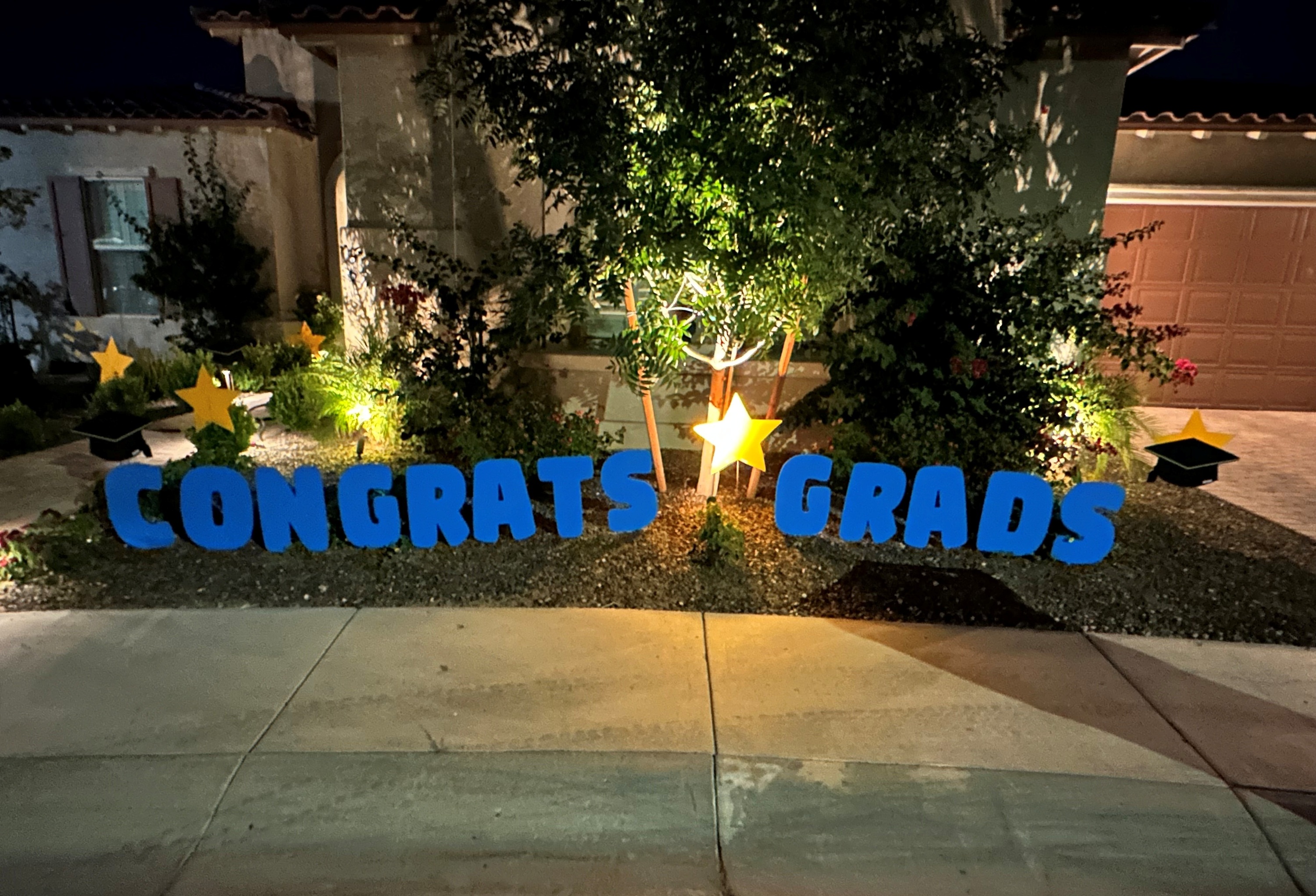 50 flamingos in yard for a graduation announcement near Peoria