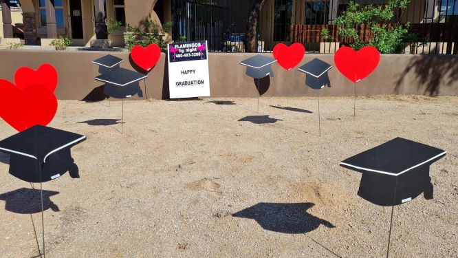 Graduation caps and hearts yard sign