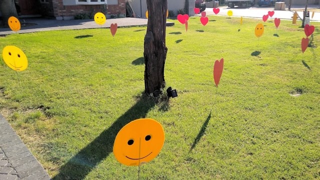 big red hearts and smiles decorations in yard