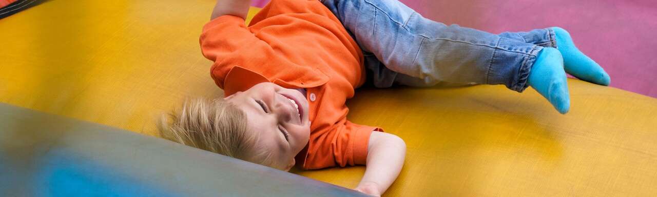 Kids enjoying water slide bounce house combo with mixed age groups