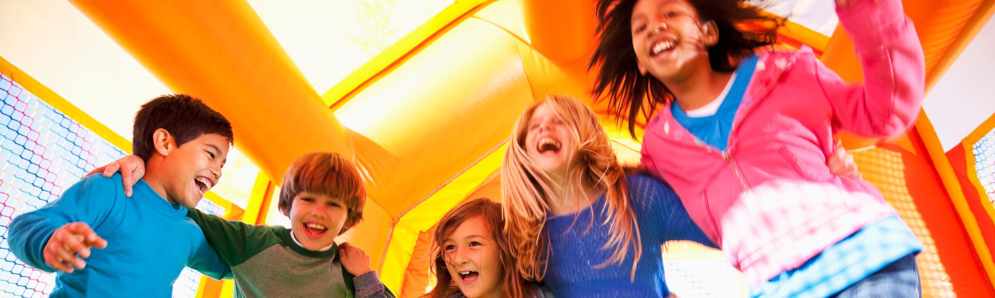 Kids jumping in a bounce house rental