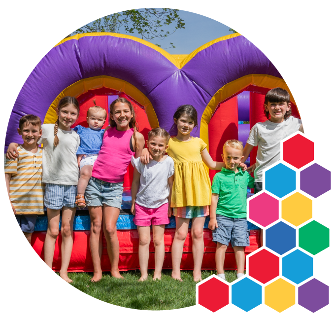 Children enjoying an outdoor party with rentals from Busy Bee Jumpers in Rhode Island Children enjoying an outdoor party with rentals from Busy Bee Jumpers in Rhode Island