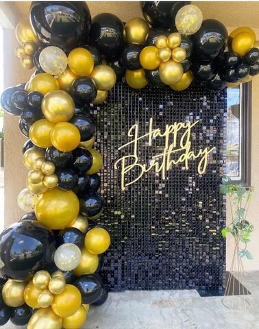 Black and gold backdrop with happy birthday, sign and balloon arch