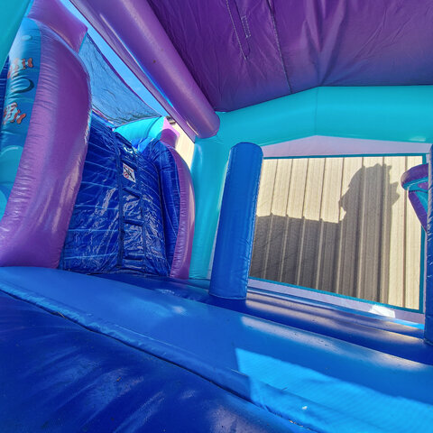 inside purple mermaid bounce house FL