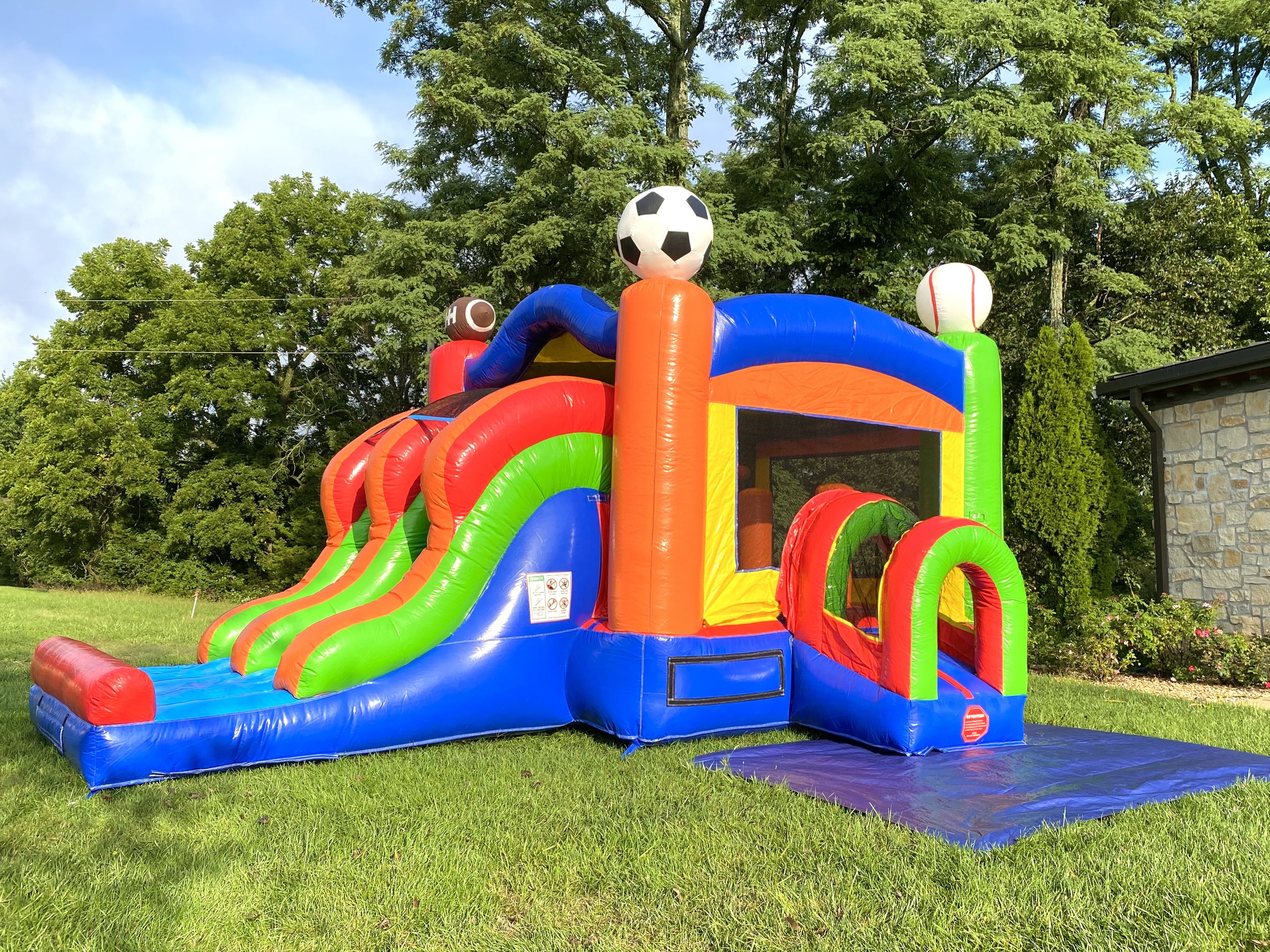 Sports theme bounce house with water slide
