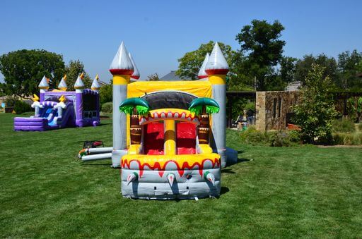 front view of dinosaur combo inflatable with slide