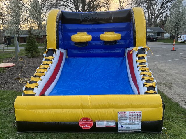 The Mini Hoop Shot Inflatable Basketball Game is featured outdoors in a residential backyard, ready for play, showcasing its suitability for private events and family gatherings.