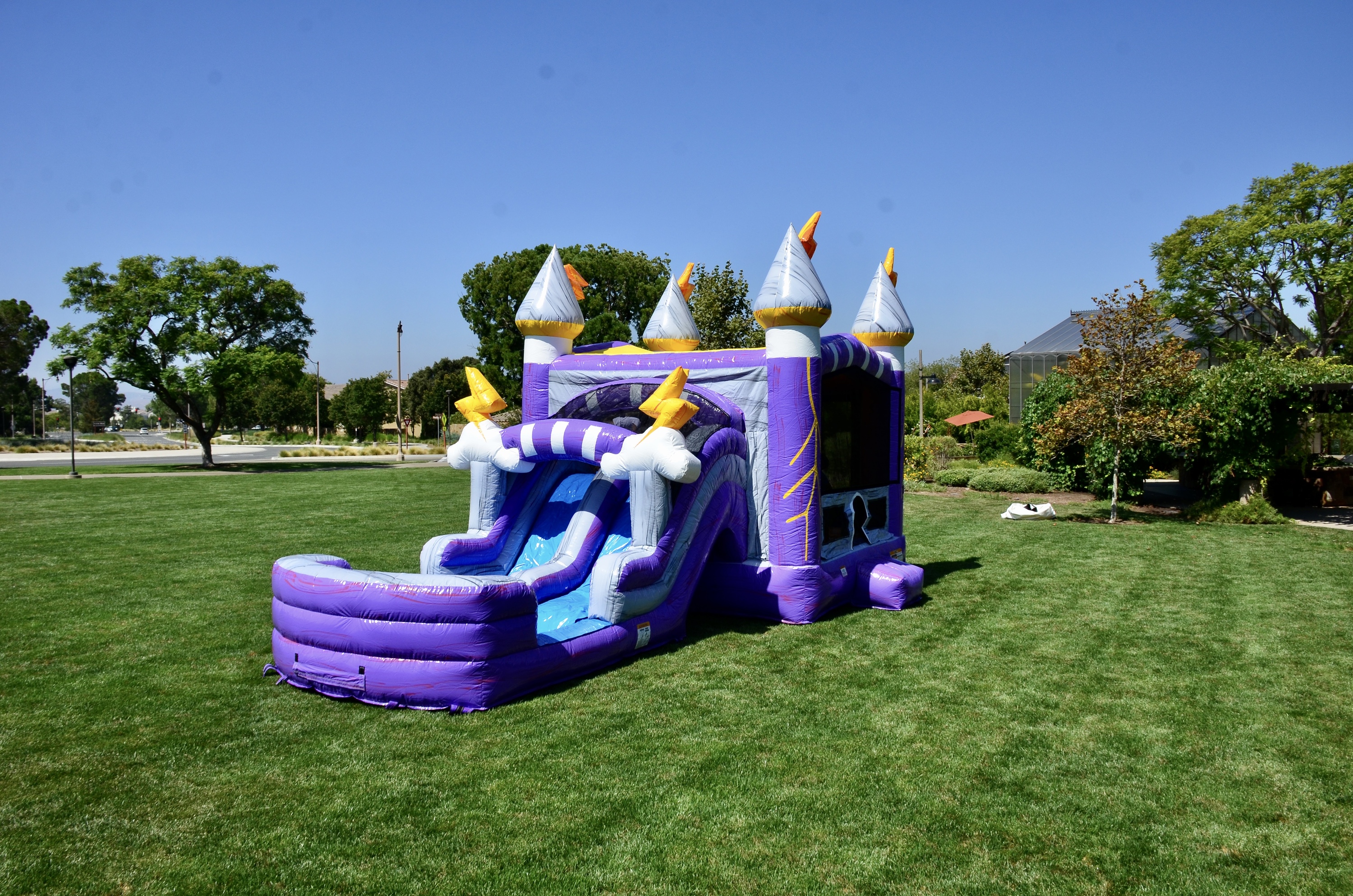 bounce house with slide on green grass